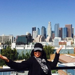 Sparkle E in front of a city